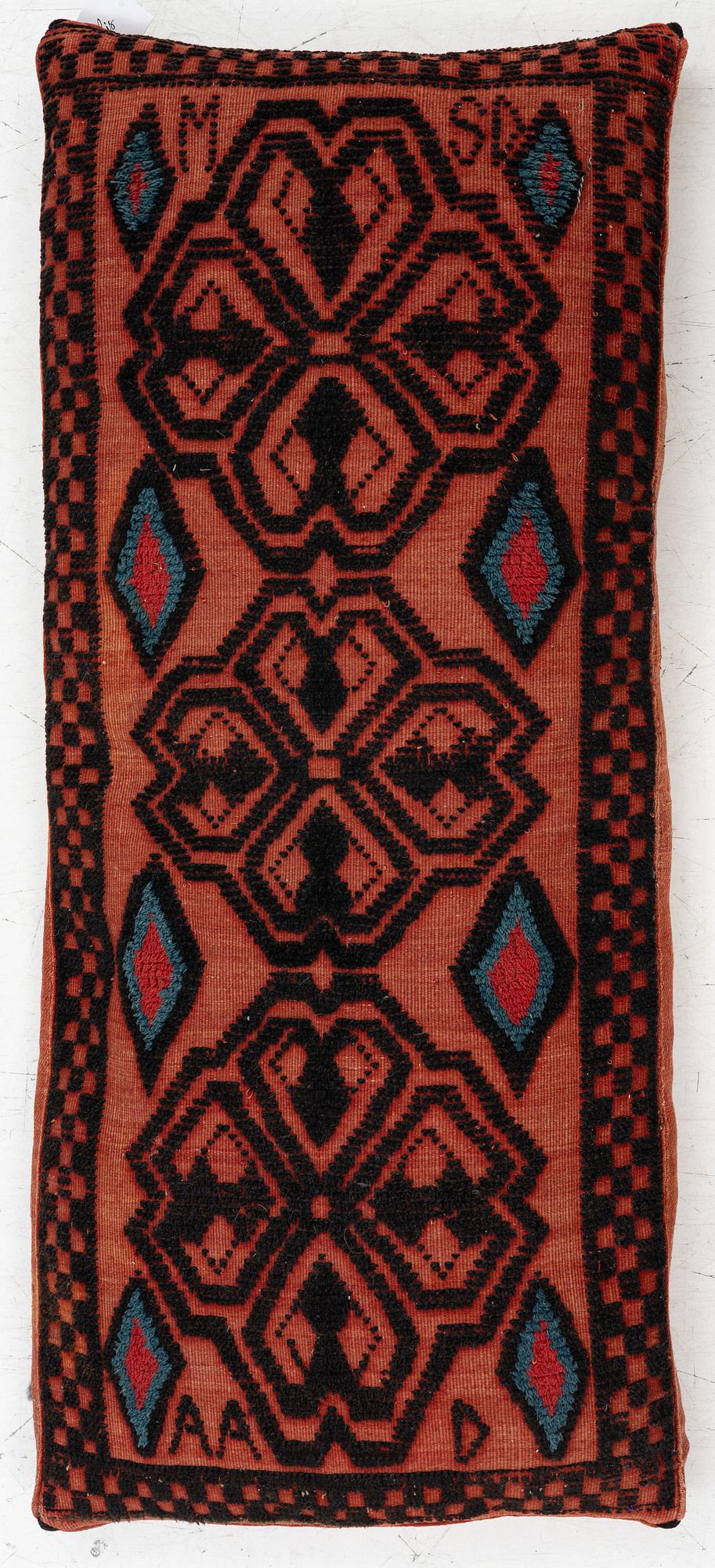 A carriage cushion, knotted pile in relief, ca 106 x 47, southwest of Scania, Sweden, circa 1800.