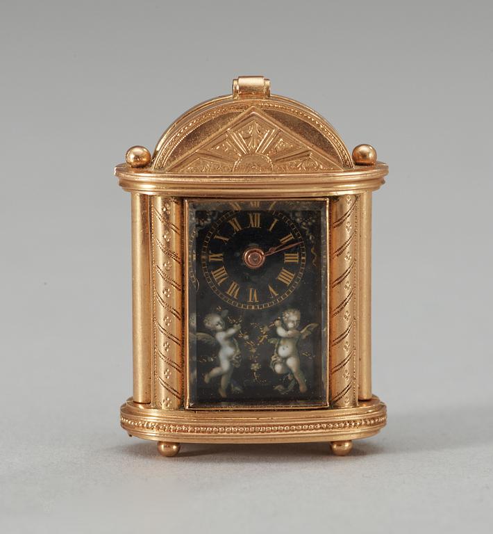 An early 20th century gold and enamel miniature clock.