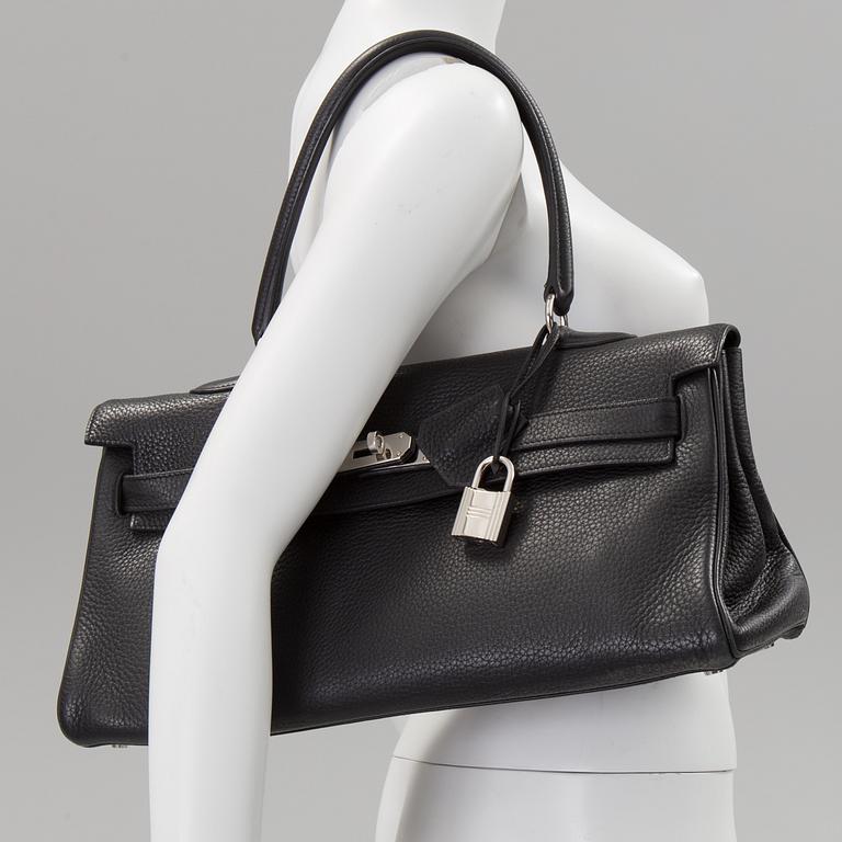 A black togo "JPG Shoulder Kelly 42" by Hermès 2009.