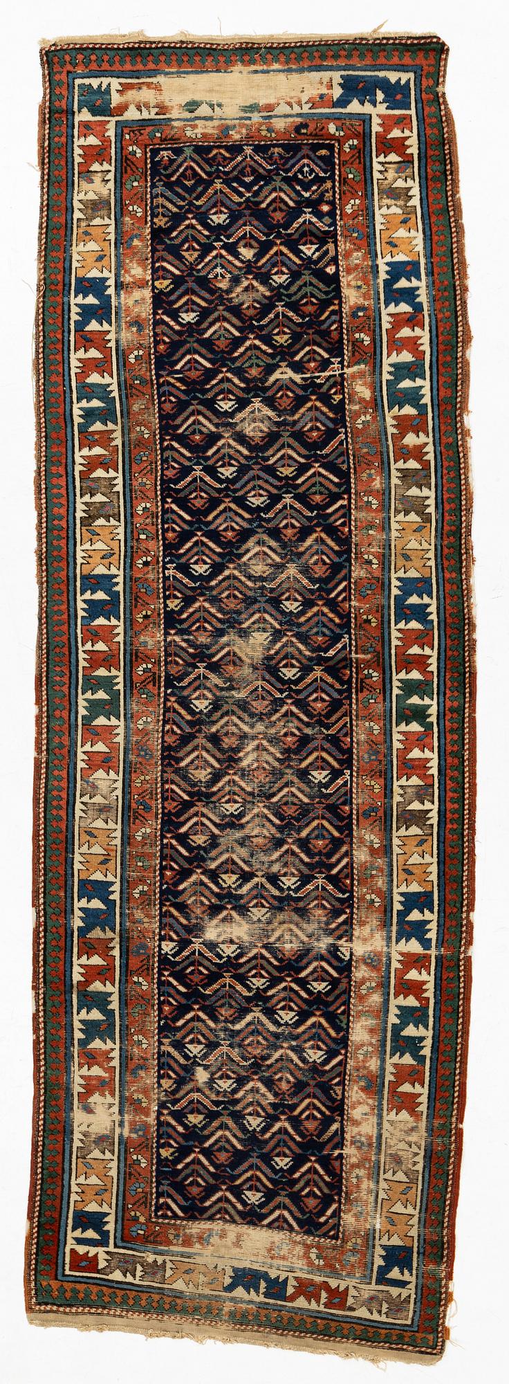 A antique Kazak gallery carpet, ca 310 x 105 cm.