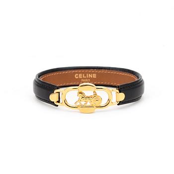 CÉLINE, a black leather bracelet.