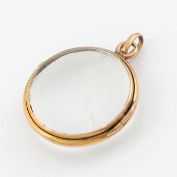 Medaljong, guld och glas.