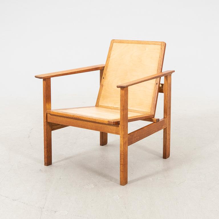 A stained wooden armchair later part of the 20th century.