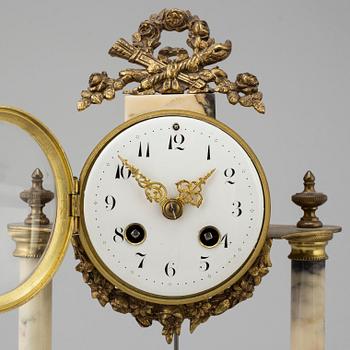 A marble and brass pendulum clock, first half of the 20th century.