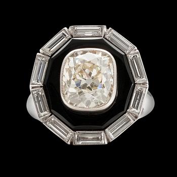 A RING platinum, onyx. Cushion cut diamond 5.20 ct + baguette cut diamonds 2 ct. In total 7.20 ct. France.