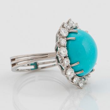 An 18K white gold ring set with a cabochon-cut turquoise and round brilliant-cut diamonds.