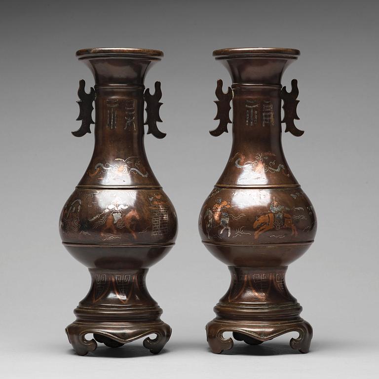 A pair of bronze vases with copper and silver inlay, Qing dynasty (1664-1912).