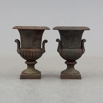 A pair of 20th century iron garden urns.