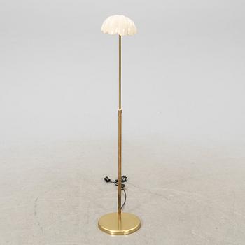 A late 20th Century floor lampp with a shell formed shade.