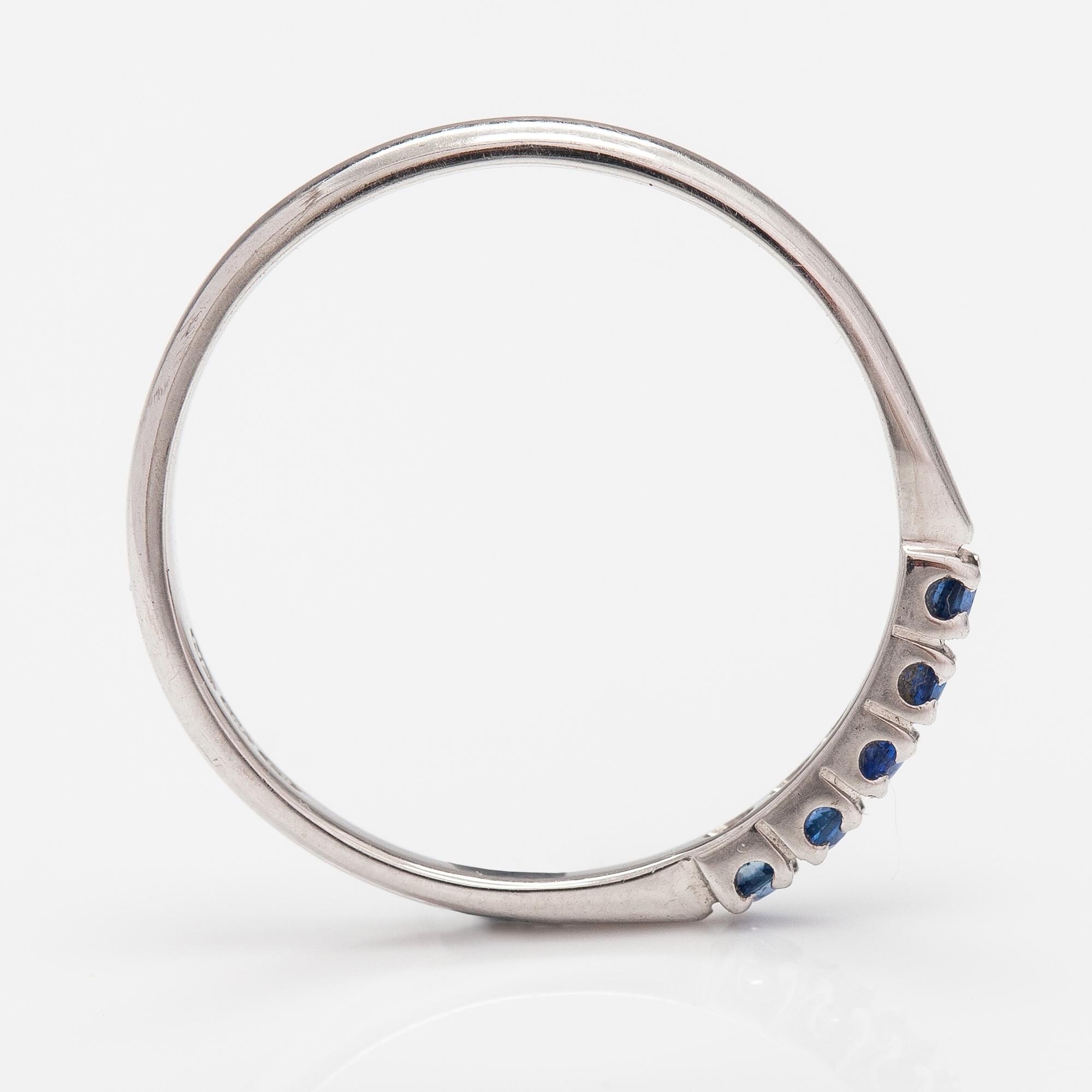 A 14K white gold ring with sapphires.