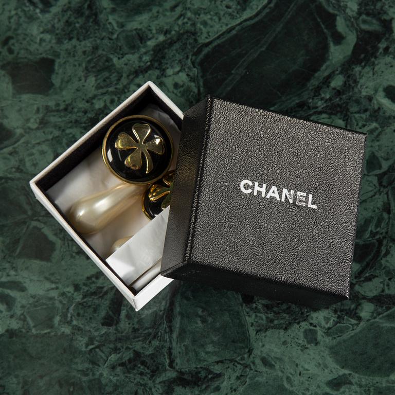 Earclips by Chanel.