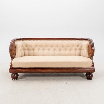 An early 1900s Art deco walnut sofa.