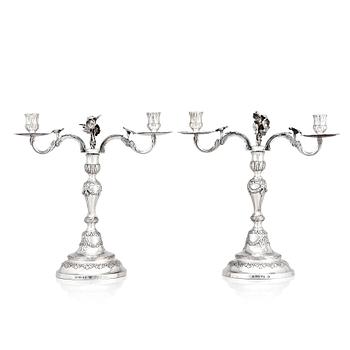 A pair of Swedish 18 century silver candelabras, mark of Lars Åkerblom Gävle 1775, arms by Christian Kullberg.