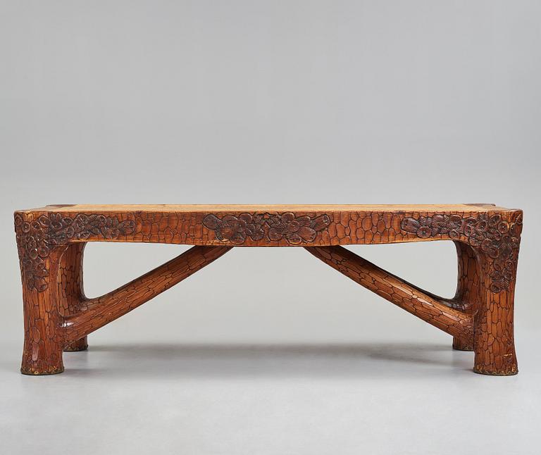 Gustaf Fjaestad, an Art Nouveau carved pine table, Arvika Sweden 1914, a double to the table in the Thiel Collection,