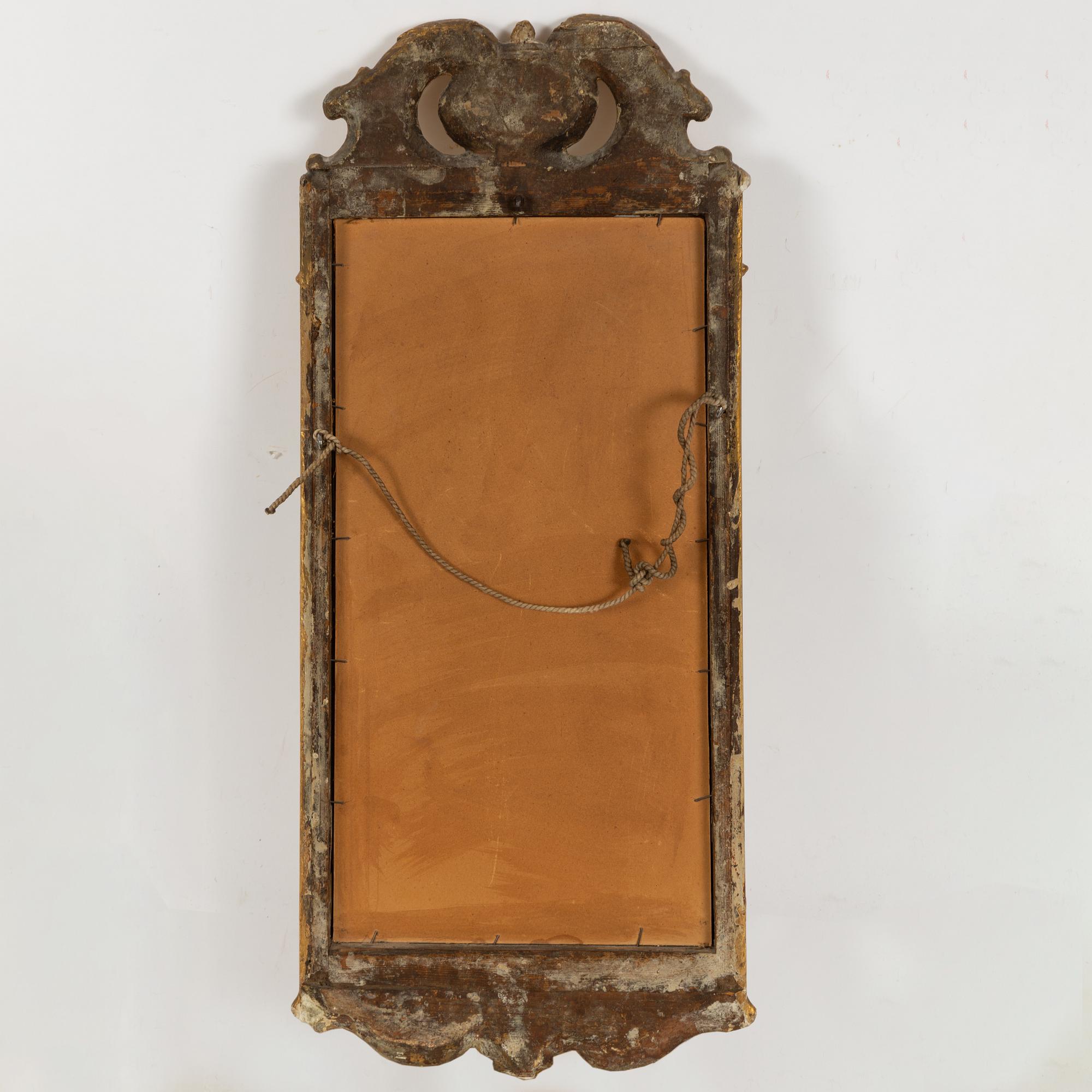 A rococo mirror, mid 18th century.