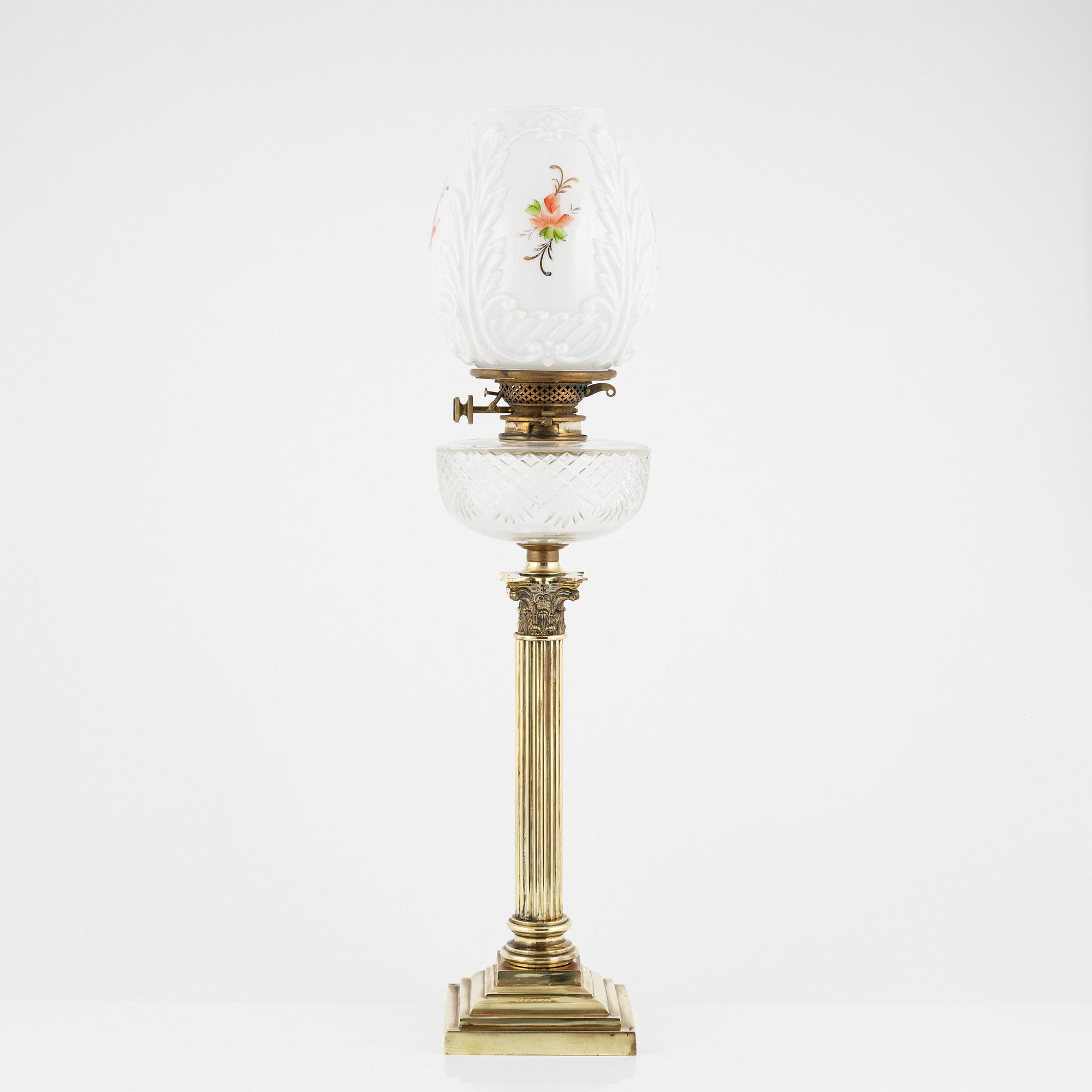 A brass and glass column shaped paraffin lamp, end of the 19th Century.