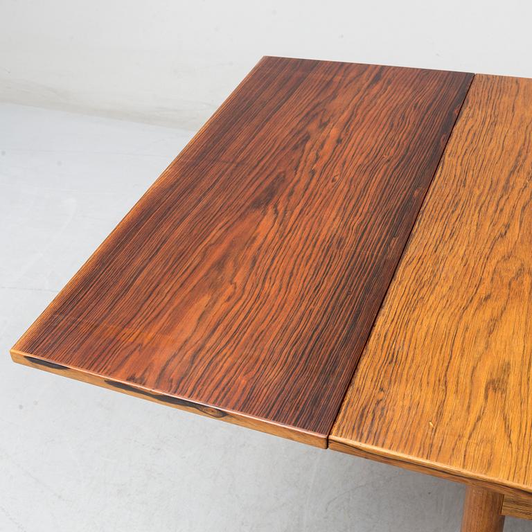 A Danish rosewood dining table, six chairs and a pair of armchairs, 1950's/60's.