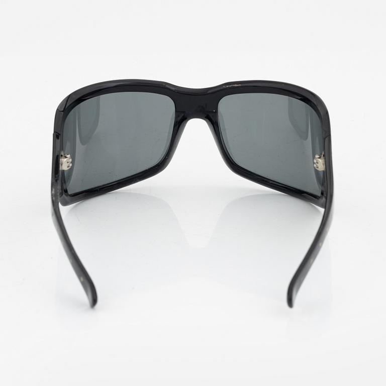 Bottega Veneta, a pair of sunglasses.
