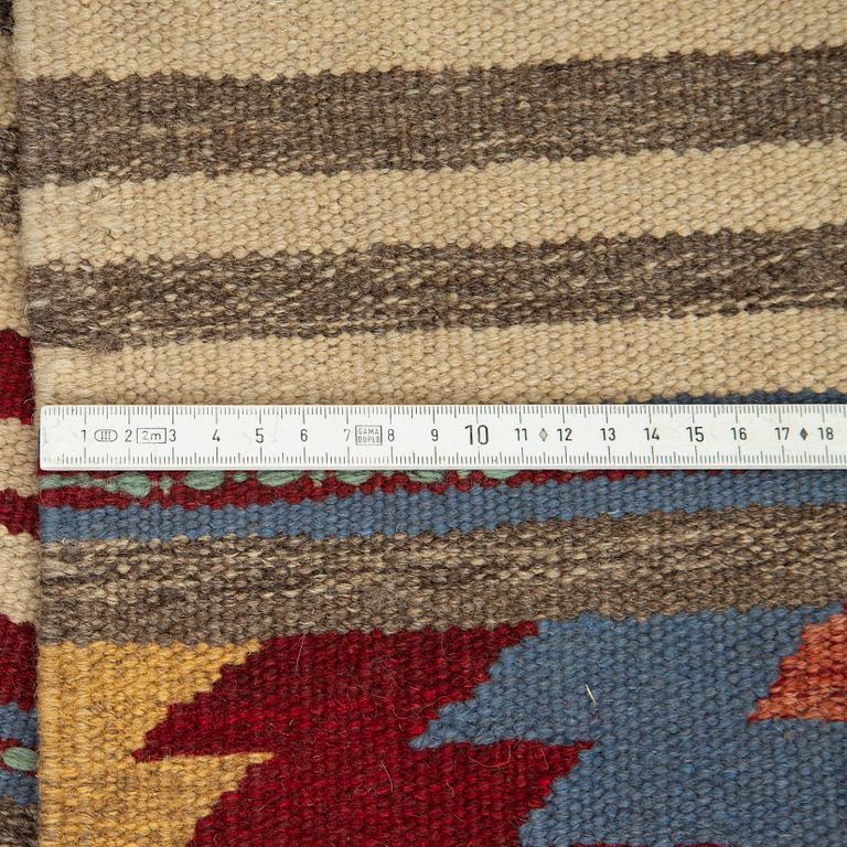 A persian kilim runner, c 246 x 64 cm.