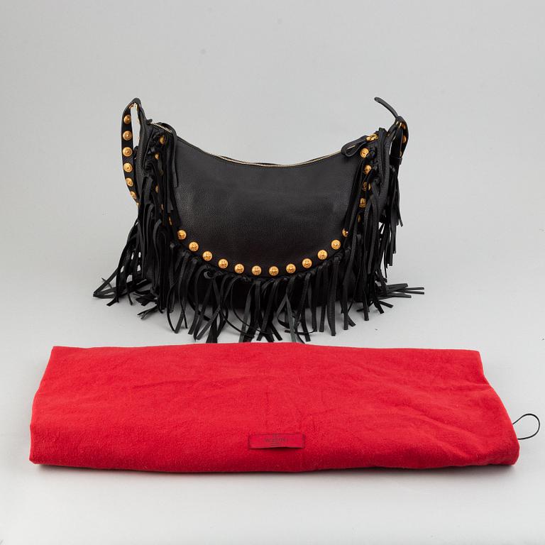 Valentino, a black leather hobo bag.
