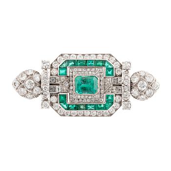 An 18K white gold Marchak art deco brooch set with step-cut emeralds.