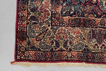 A carpet, semi-antique Kerman Laver, ca 242 x 142 cm.