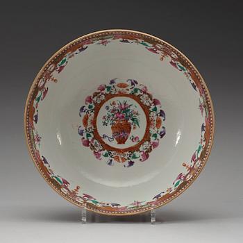 A large famille rose punch bowl, richly decorated with palace scenes, Qing dynasty, 18th century.