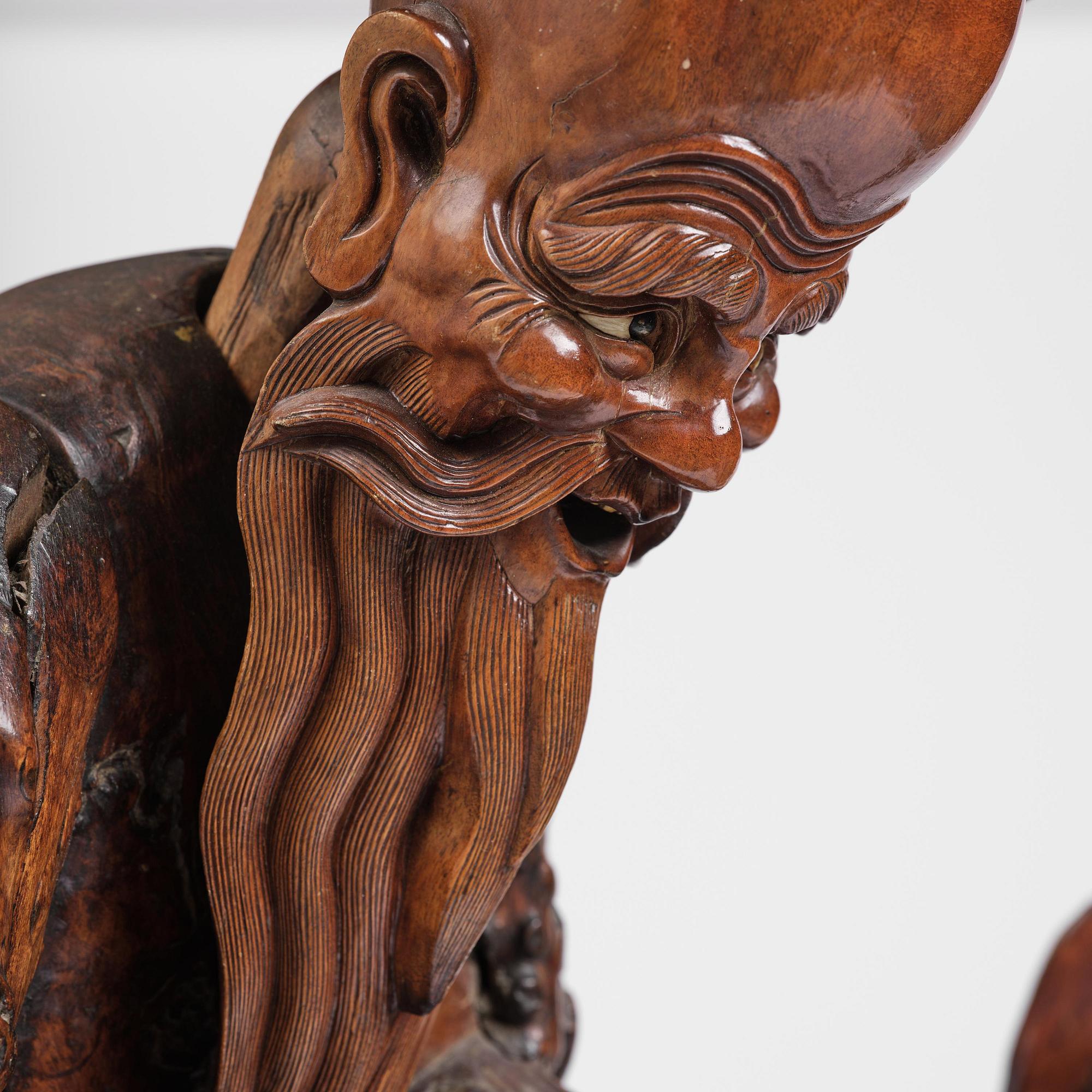 A large well sculptured root sculpture of 'Sholau and attendant', late Qing dynasty, 19th century.