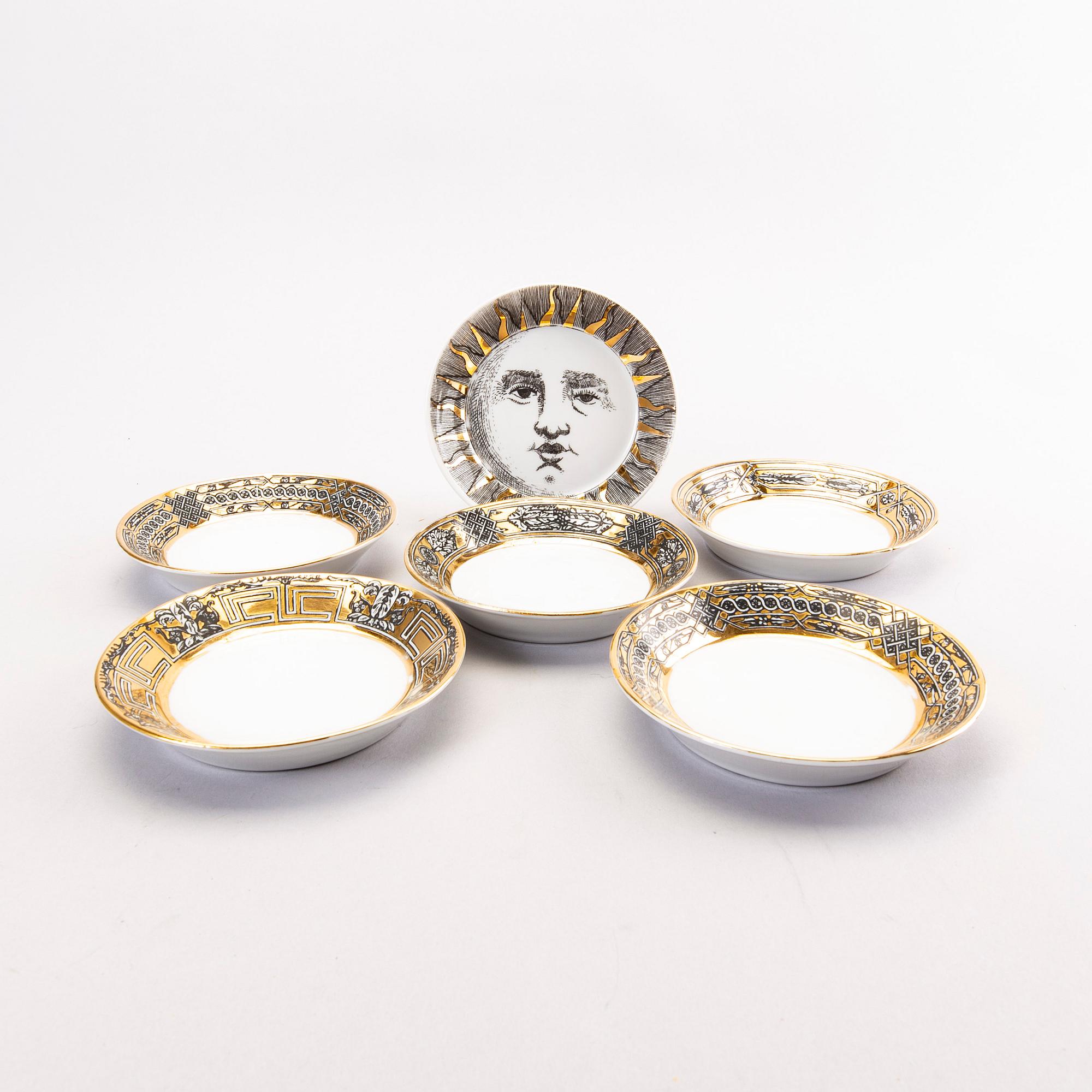 Piero Fornasetti a set of four coffee cups with saucers and two ashtrays.
