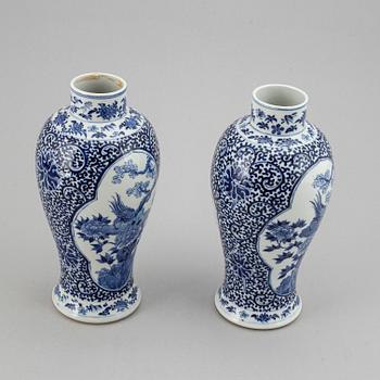 A pair of blue and white vases, Qing dynasty, late 19th century, with a Kangxi mark to the base.