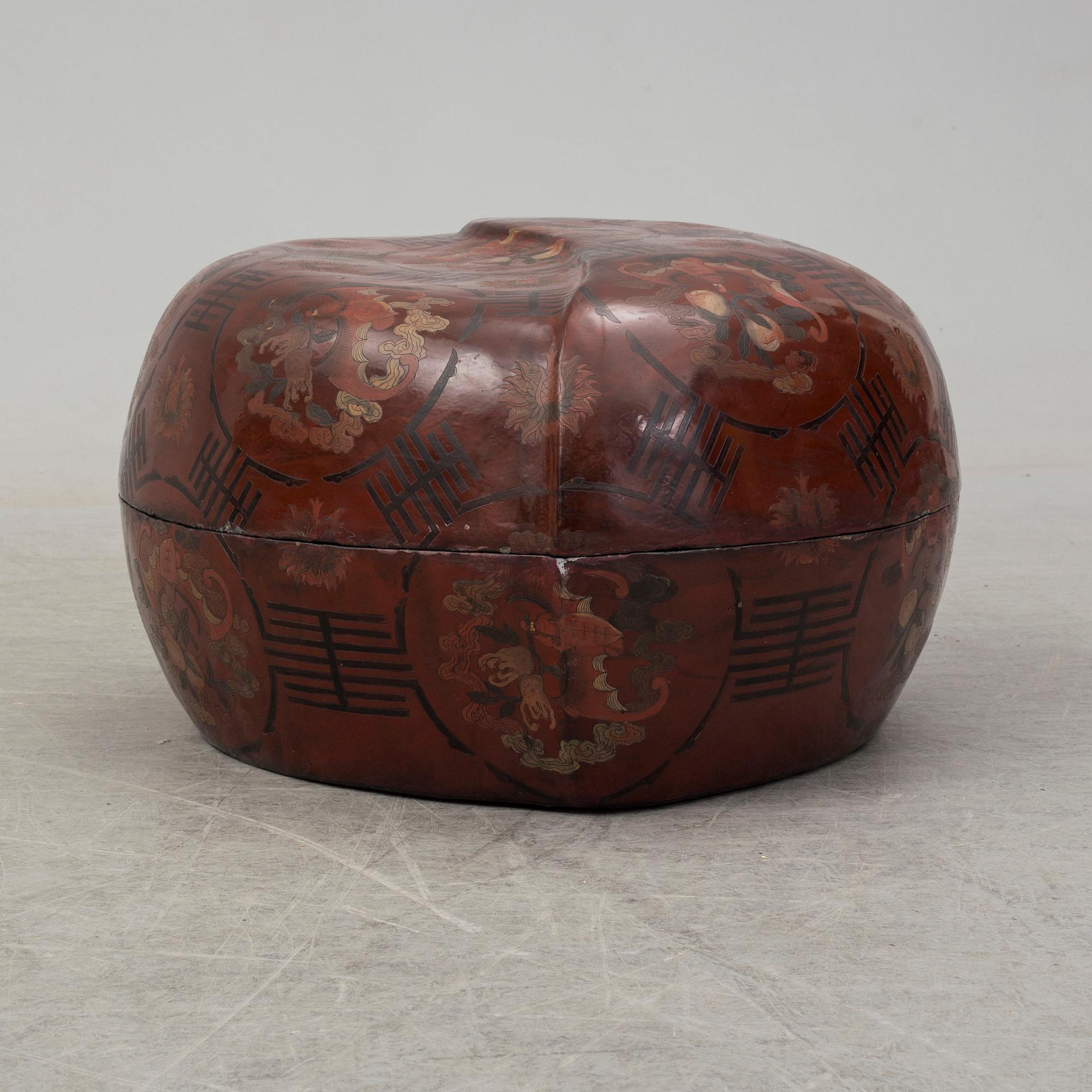 A massive Japanese wooden and lacquered box with cover, in the shape of a peach, early 20th century.