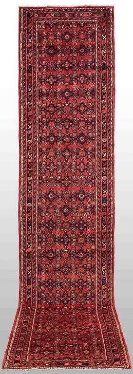 A Hosseinabad carpet, c. 430 x 90 cm.