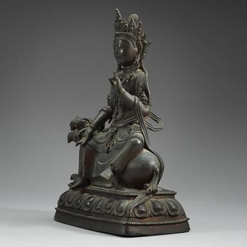 A large bronze figure of Bodhisattva seated on a mythical beast, Qing dynasty, 18/19th Century.