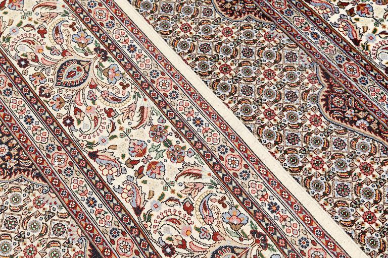 A part silk Moud carpet, approximately 350 x 252 cm.