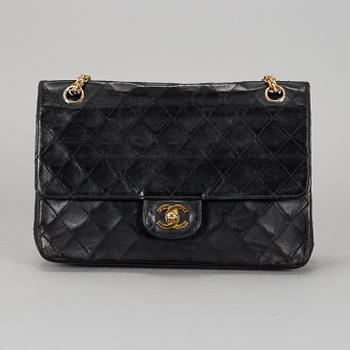CHANEL, a quilted black leather 'Double Flap Bag'.