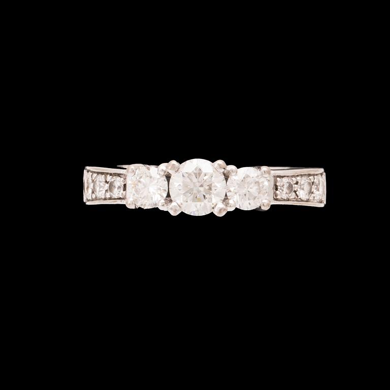 An 18K white gold ring set with round brilliant cut diamonds.