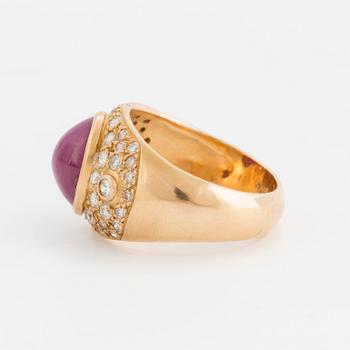 A cabochon cut opaque ruby and brilliant cut diamond ring.