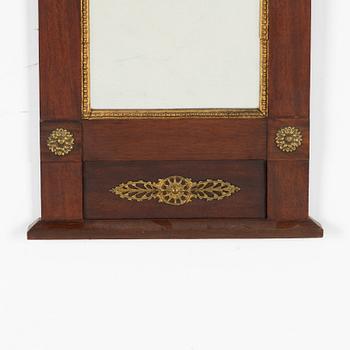 An Empire style mirror, circa 1900.