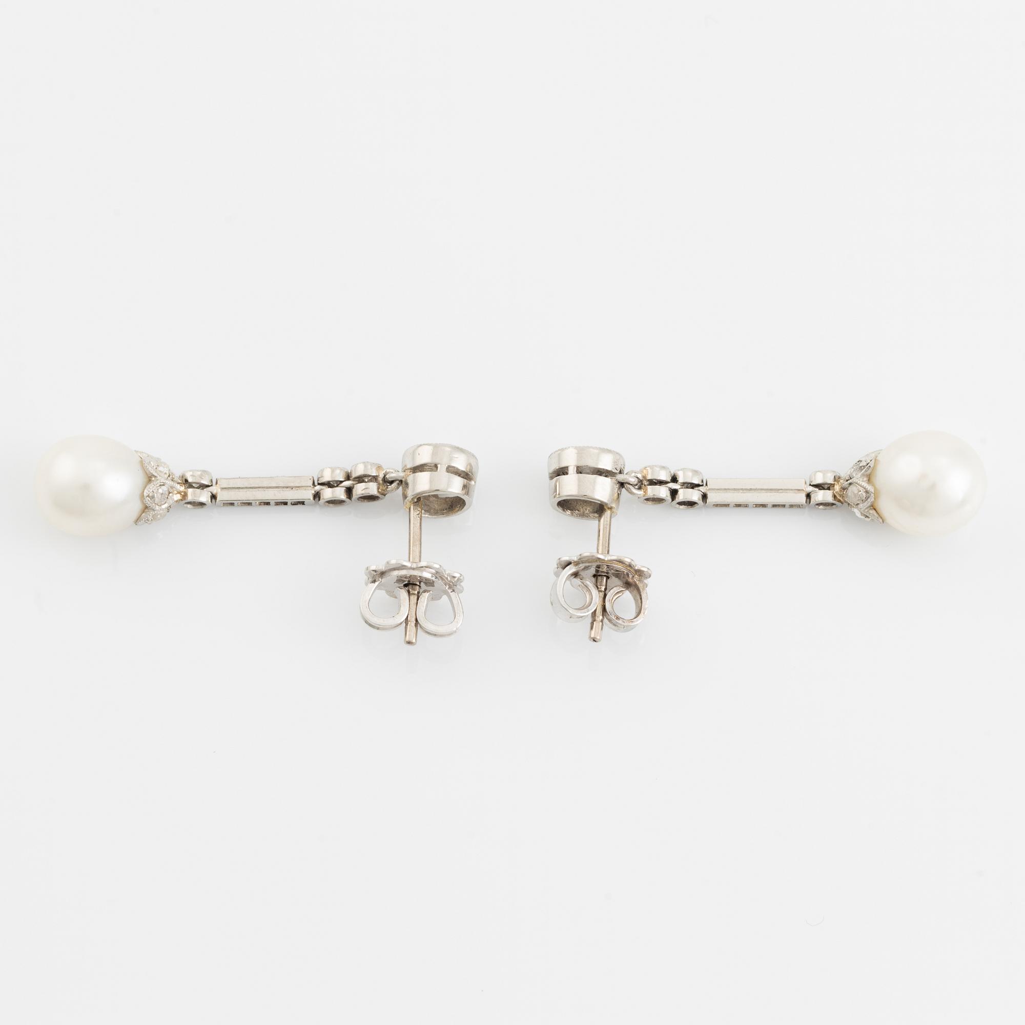 A pair of platinum pearl earings.