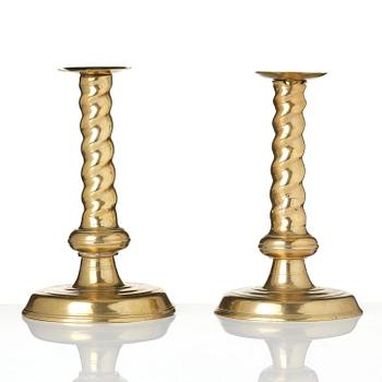 A pair of Northern European cast brass baroque candlesticks, circa 1700.