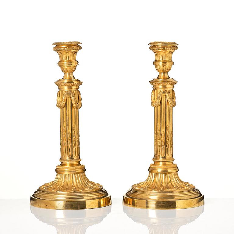 A pair of Louis XVI candlesticks in the manner of Jean Louis Prieurs.