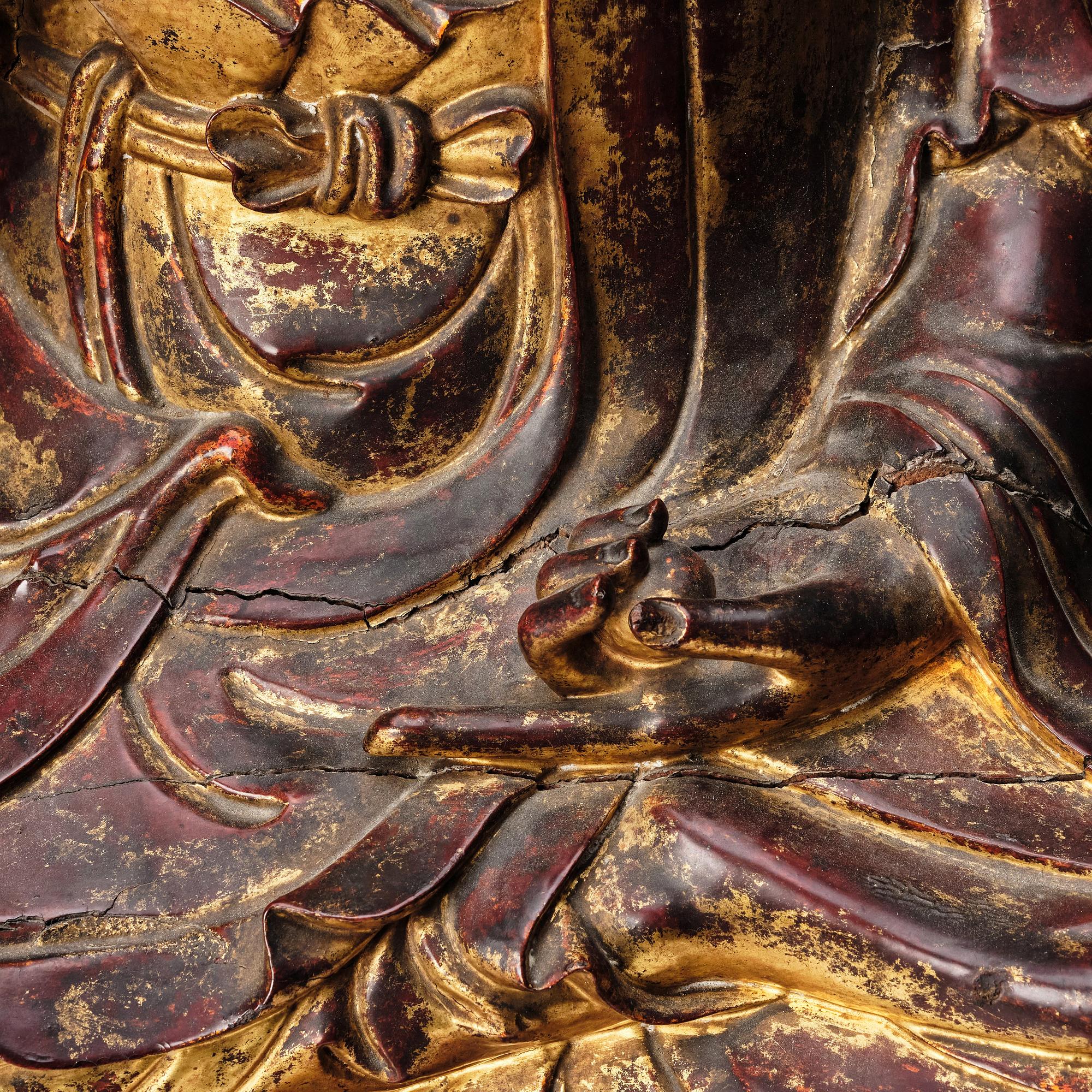 A large gilt and lacquered figure of a seated buddha, Qing dynasty, 19th Century.