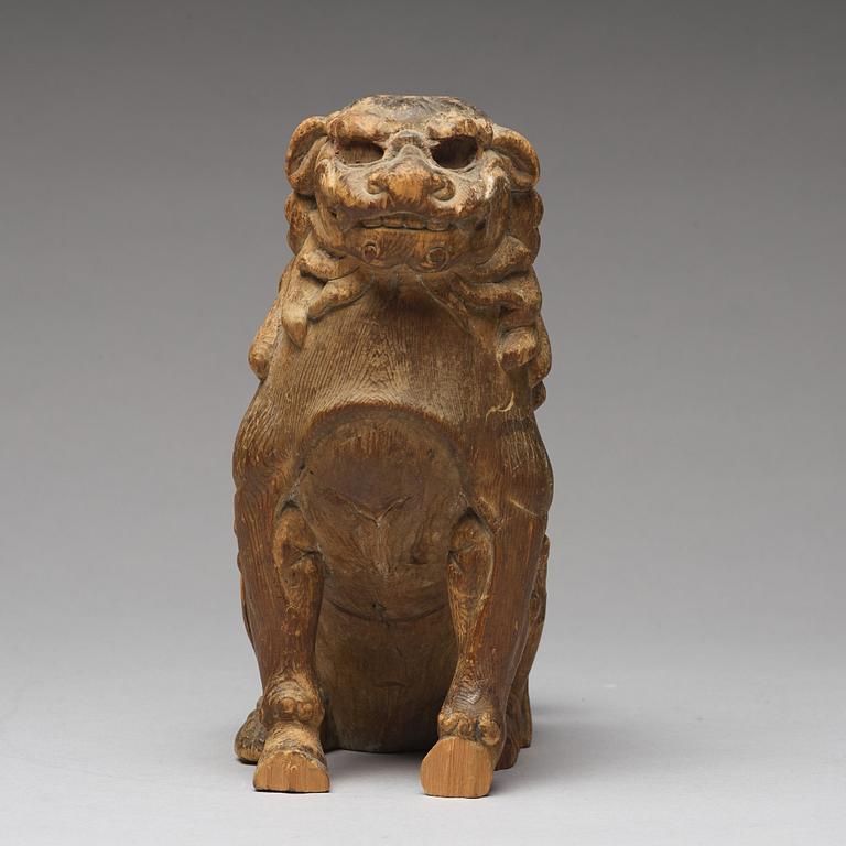 A wooden sculpture of a buddhist lion, Qing dynasty, 19th Century.