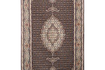 A Tabris rug, part silk, c. 198 x 81 cm.