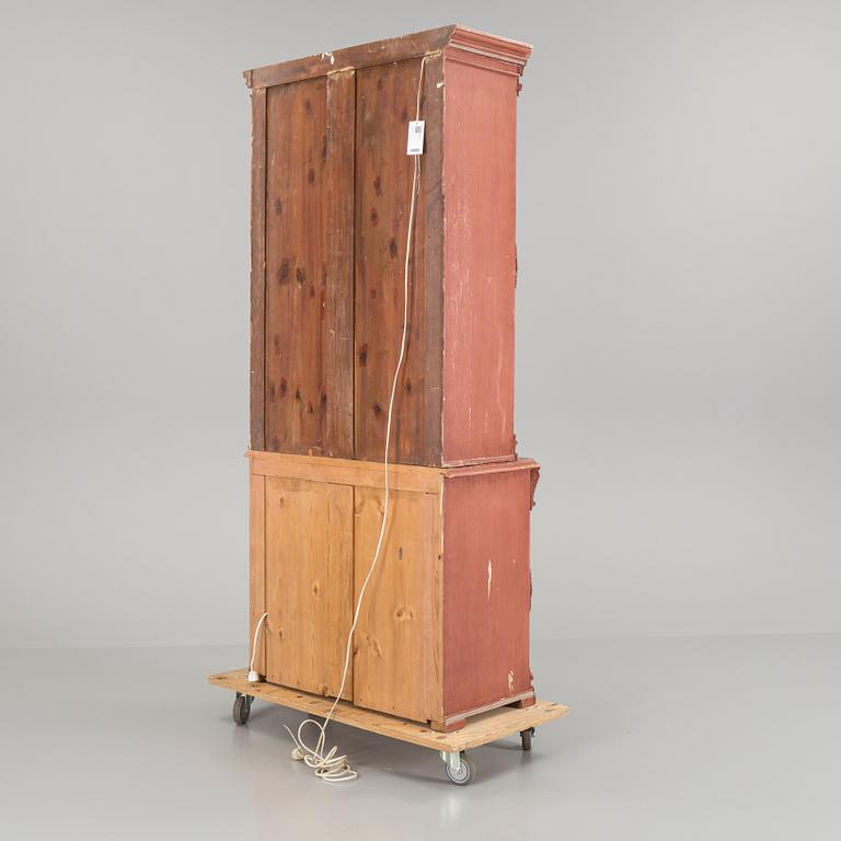 A pained late 19th century vitrine book cabinet in two sections.