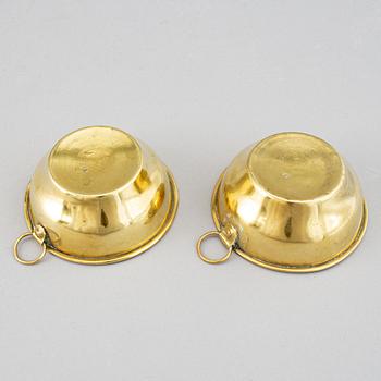A pair of brass candelabra for two candles "Blekingestakar and a pair of brass cups, 1800/1900.