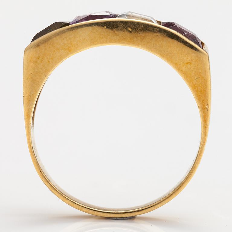 An 18K gold ring with an amethyst, garnet, topaz and peridote.