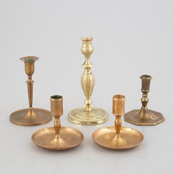 A set of five brass candlesticks, 18th / 19th Century.