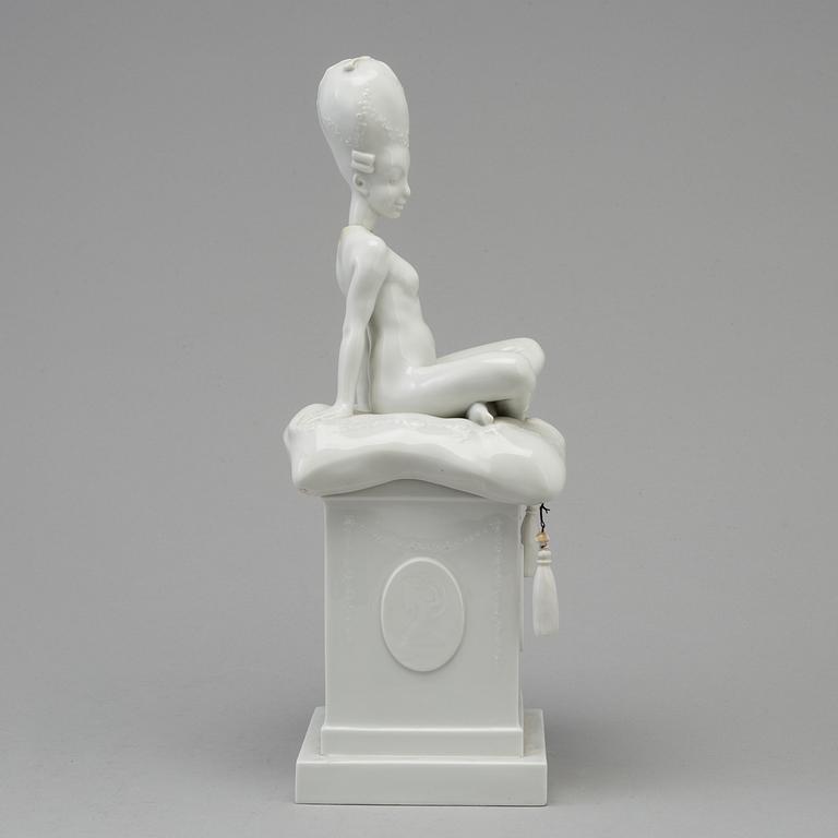 A white glazed Royal Copenhagen porcelain nodding head figure, Denmark, early 20th Century. Not first quality.