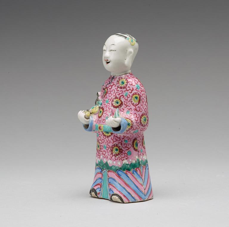 A famille rose figure of a laughing boy, Qing dynasty, circa 1800.